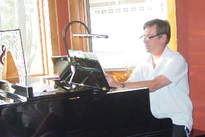 Herb Berendsen, sitting at a piano